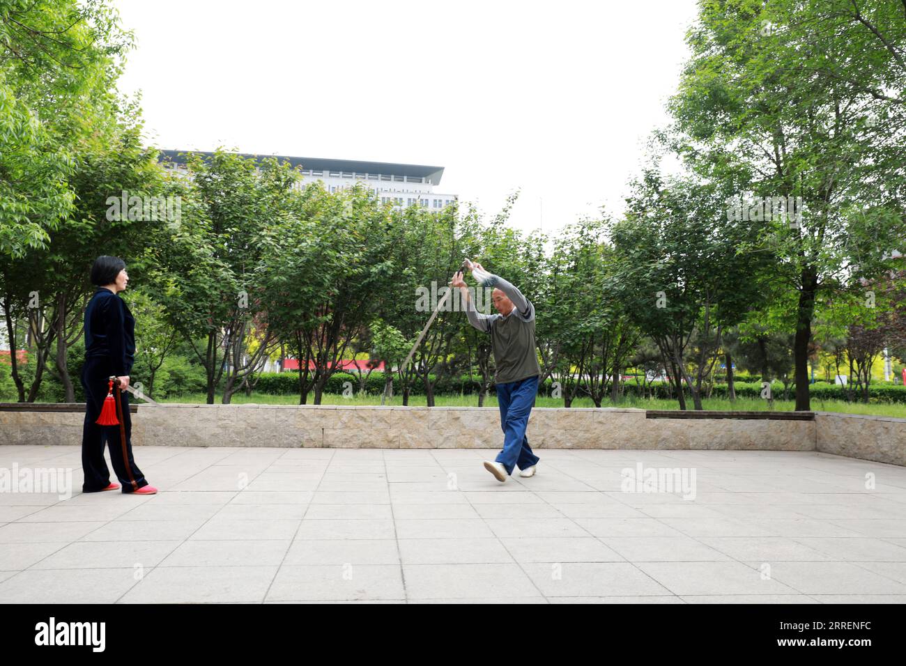 LUANNAN COUNTY, Hebei Province, China - May 4, 2020: two people practice Taiji sword in a park. Stock Photo