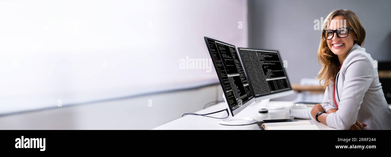 Programmer Woman Coding On Multiple Computer Screens Stock Photo