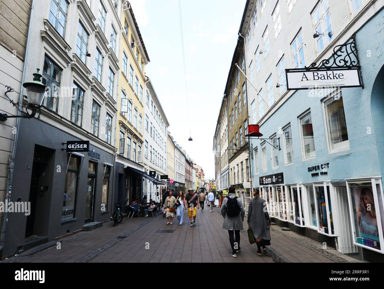 Walking on Fiolstræde pedestrian street in Copenhagen, Denmark. Stock Photo