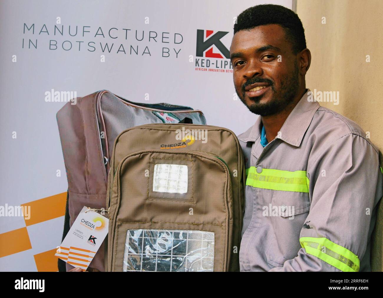 220331 -- GABORONE, March 31, 2022 -- Kedumetse Liphi, the 31-year-old innovative creator of Chedza Solar Backpacks, shows a solar backpack in Gaborone, Botswana, on March 21, 2022. In the first week of April, disadvantaged children in Botswana villages such as Tshono, Mokhomba, Lefoko and Sevrelela will receive Chedza Solar Backpacks that will enable them to study at night. Photo by /Xinhua TO GO WITH Feature: Solar backpacks aid students learning, clean energy uptake in Botswana BOTSWANA-GABORONE-SOLAR BACKPACKS SharonxTshipa PUBLICATIONxNOTxINxCHN Stock Photo