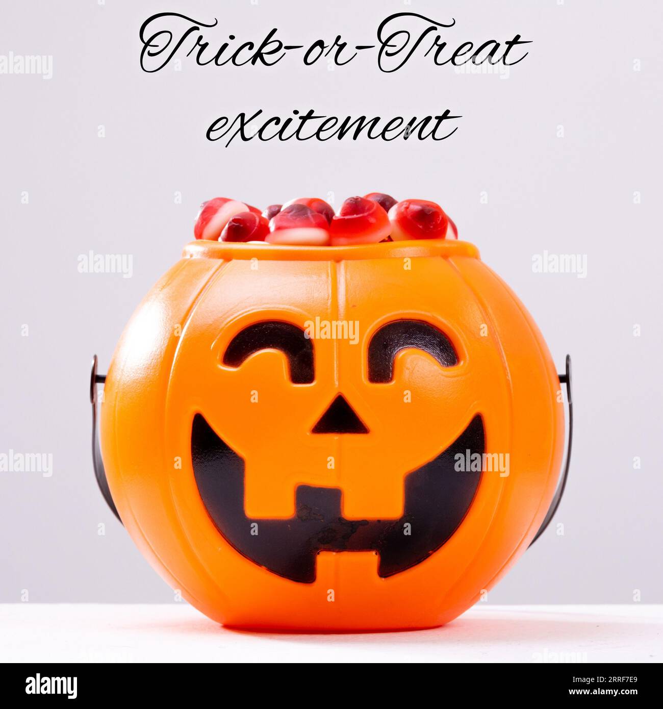 Composite of trick or treat excitement text and halloween pumpkin on white background Stock Photo