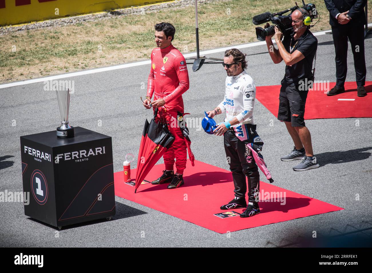 At the Spanish Grand Prix, F1 drivers Carlos Sainz and Fernando Alonso stand next to each other during a pre-race event. Stock Photo