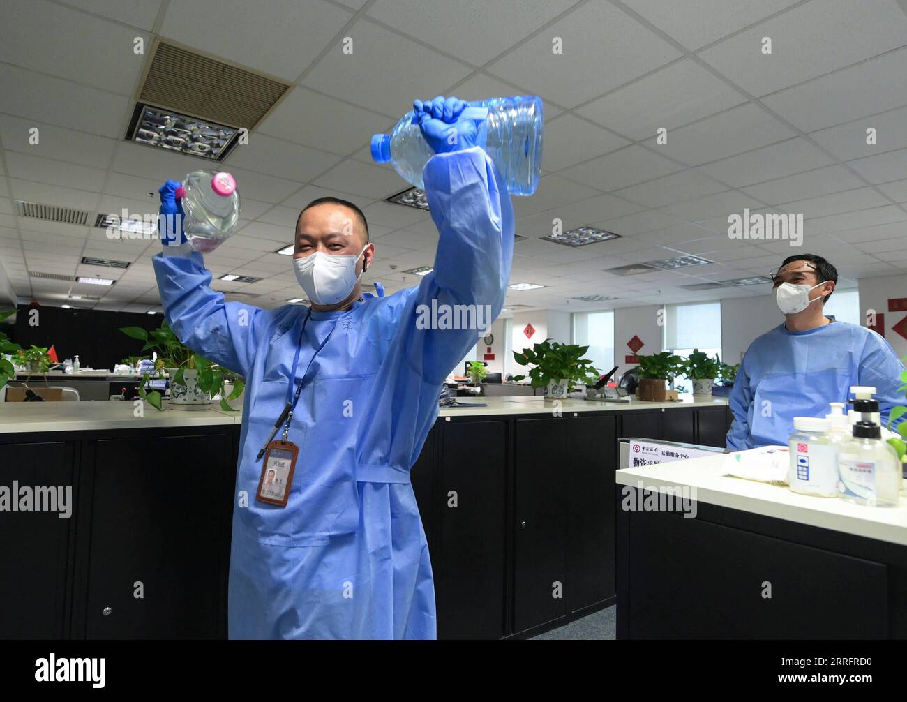 220424 -- SHANGHAI, April 24, 2022 -- Xue Feng exercises with water bottles in Shanghai, east China, April 20, 2022. Amid challenges caused by the resurgence of COVID-19 in Shanghai, financial institutions and banks have managed to remain operational. Bank of China Shanghai branch has entered temporary closed-loop management for employees on duty who are supported by an efficient logistics support team. The team is composed of three members: deputy general manager Wang Lianghui, director Han Hao and employee Xue Feng. The team is in charge of purchasing and distributing living necessities, can Stock Photo