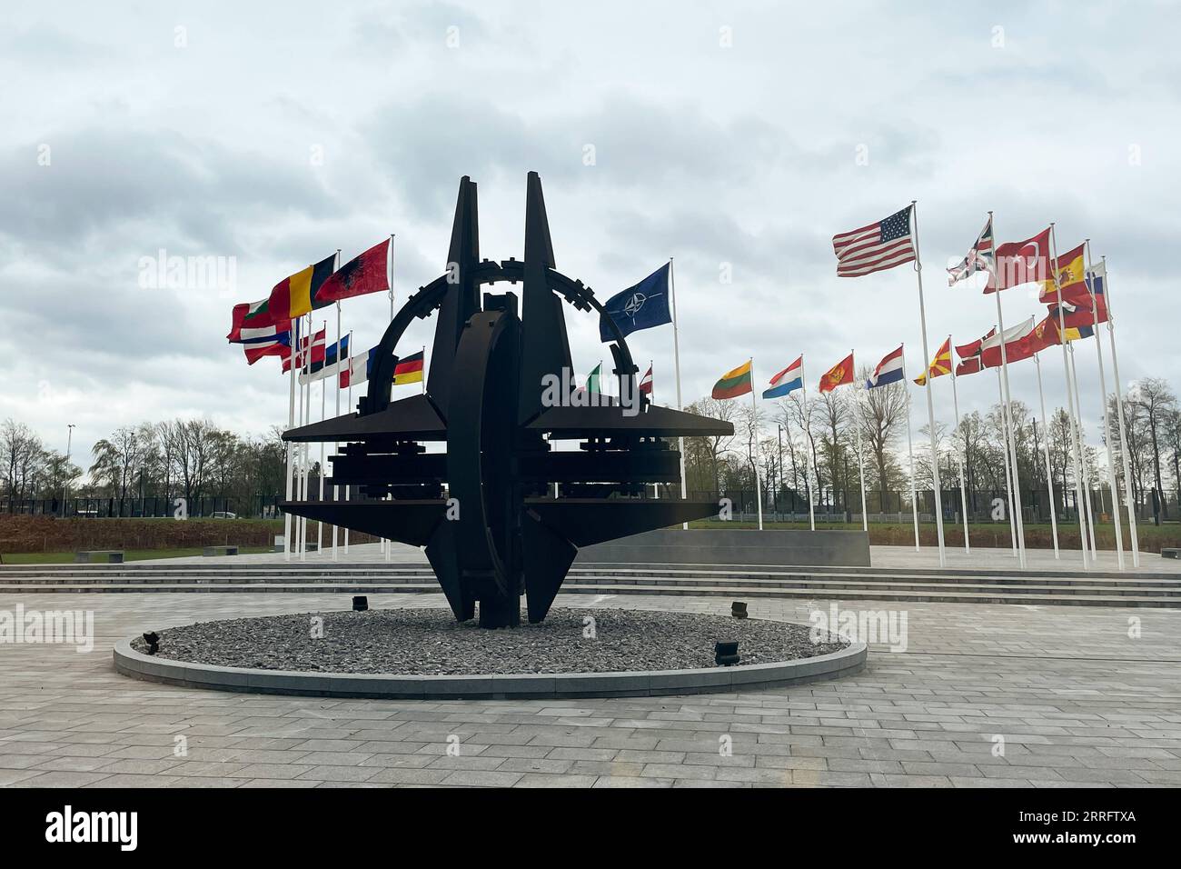 220426 -- BEIJING, April 26, 2022 -- Photo taken on April 6, 2022 shows a sculpture and flags at NATO headquarters in Brussels, Belgium.  Xinhua Headlines: Uncovering untold secrets of NATO -- a monstrous remnant from Cold War days ZhengxHuansong PUBLICATIONxNOTxINxCHN Stock Photo