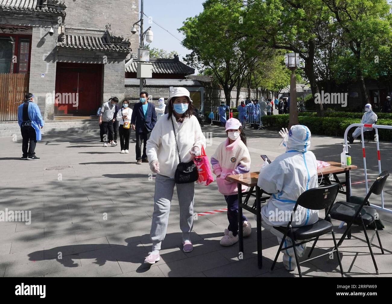 220426 -- BEIJING, April 26, 2022 -- Citizens queue for COVID-19 nucleic acid tests at a nucleic acid testing site in Dongcheng District, Beijing, capital of China, April 26, 2022. Beijing will conduct three rounds of nucleic acid testing in 11 areas from Tuesday to Saturday in efforts to curb the risk of COVID-19, local authorities said at a press conference Monday. The testing will cover people in the districts of Xicheng, Dongcheng, Haidian, Fengtai, Shijingshan, Fangshan, Tongzhou, Shunyi, Changping, Daxing and Beijing Economic-Technological Development Area, said Xu Hejian, spokesperson o Stock Photo