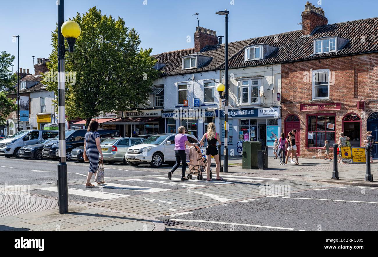 Grantham Lincolnshire - Zebra crossing or a pedestrian crossing on a very busy street with a family and pushchair crossing Stock Photo