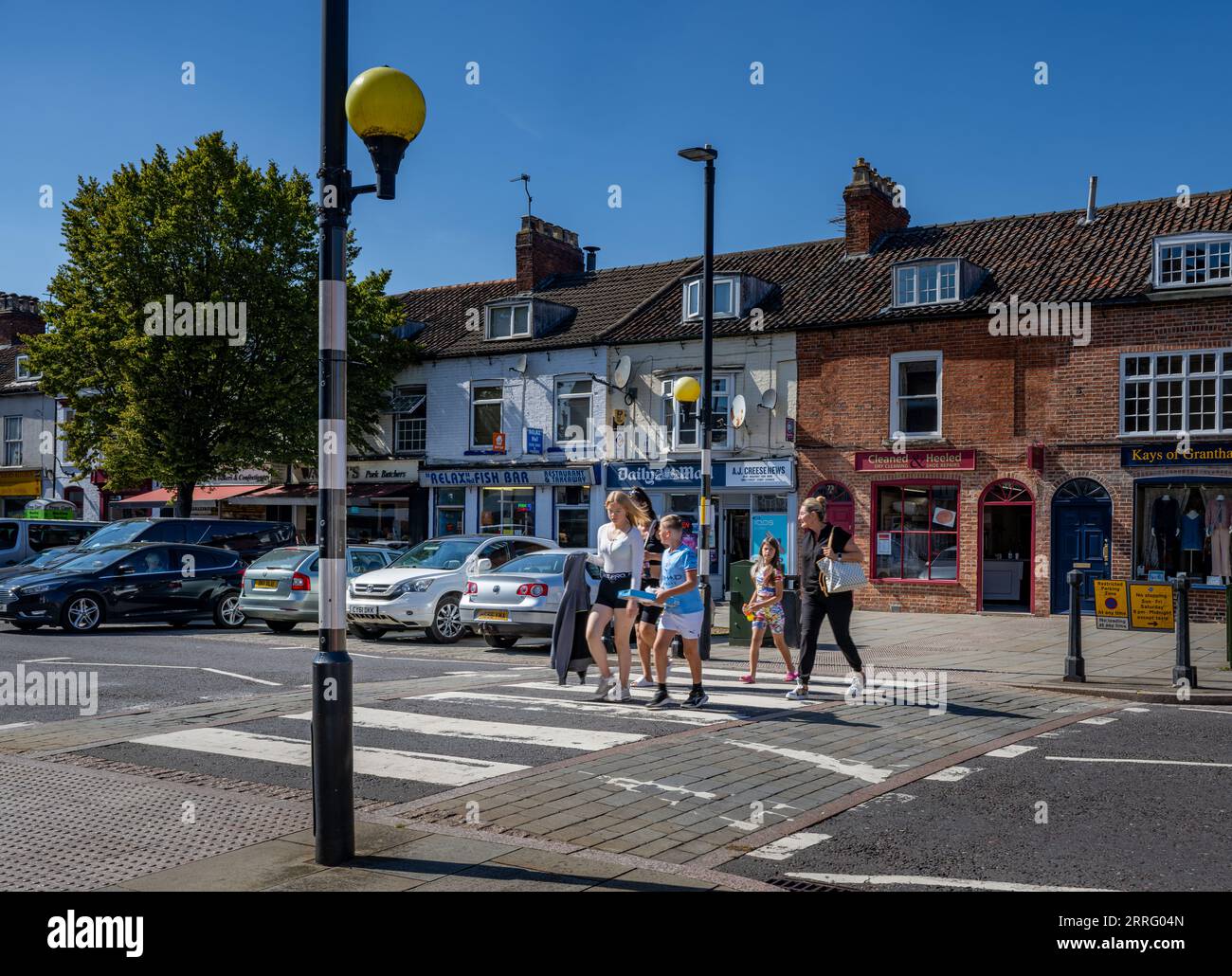 Grantham Lincolnshire - Zebra crossing or a pedestrian crossing on a very busy street with a family crossing Stock Photo