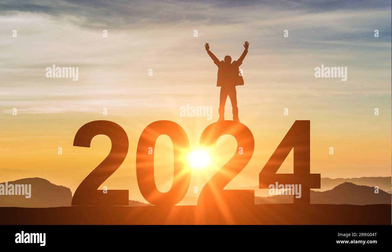 2024. New Year 2024. Man standing at top of data 2024 as sun begins to