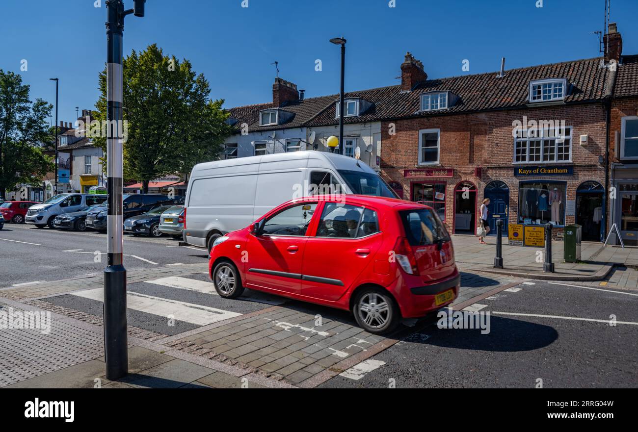 Grantham Lincolnshire - Zebra crossing or a pedestrian crossing on a very busy street with vehicles crossing Stock Photo