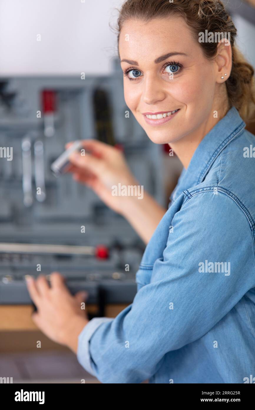 beautiful woman using toolbox smiling Stock Photo