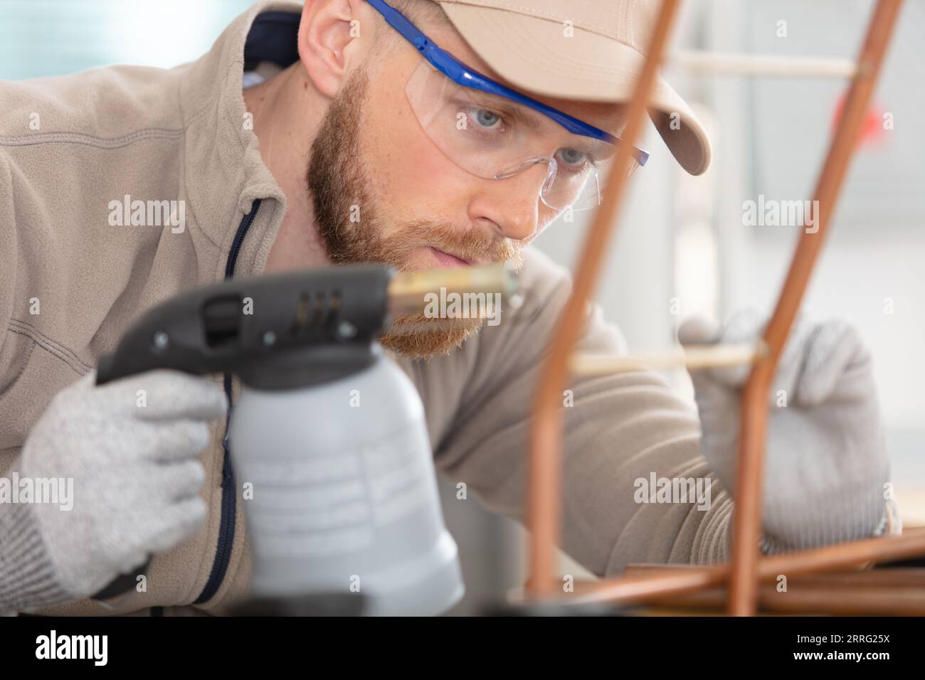 worker using blowtorch for soldering copper Stock Photo - Alamy