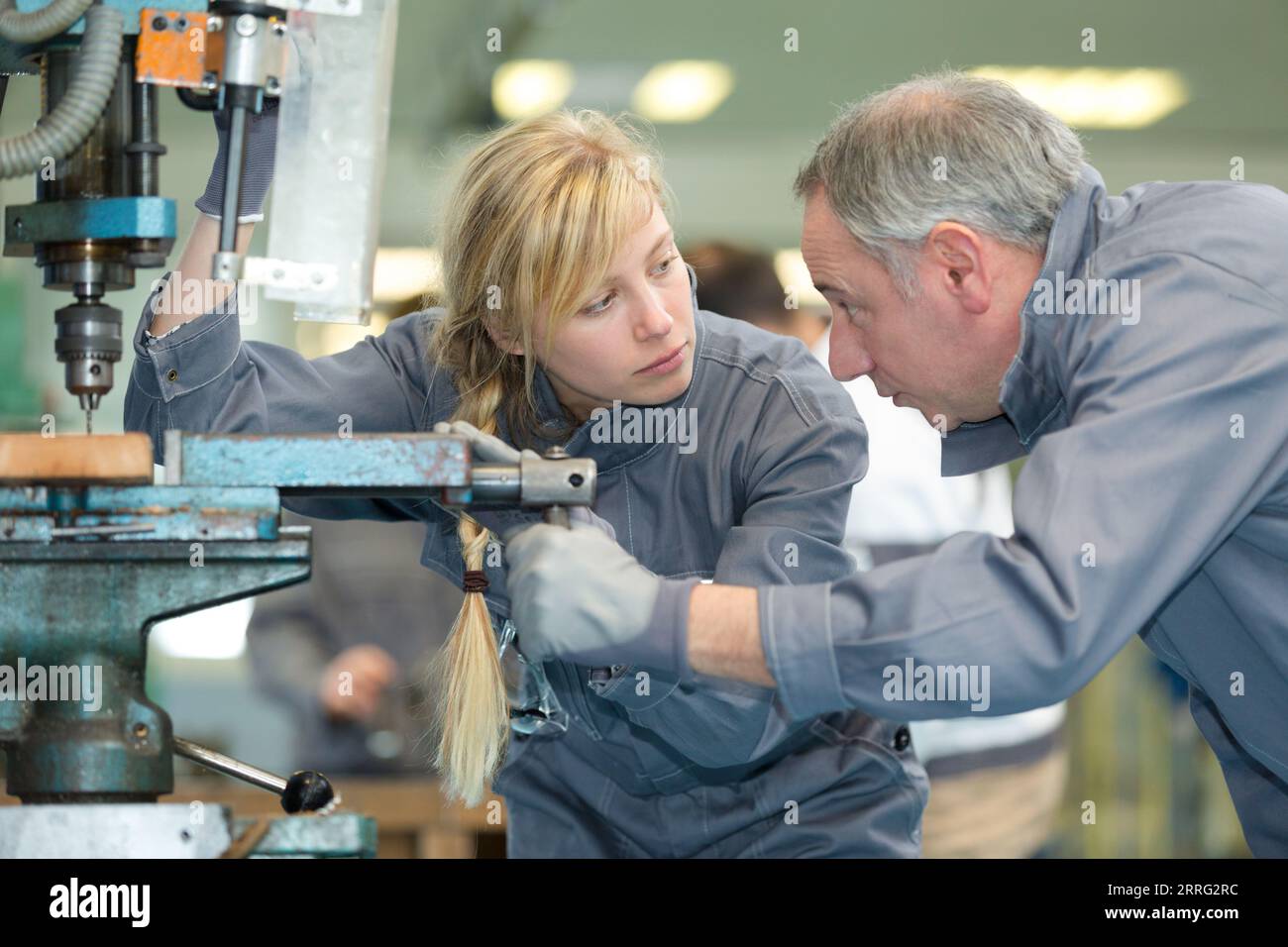 Machine Maker Apprentice engineer training female apprentice on milling machine Stock Photo - Alamy