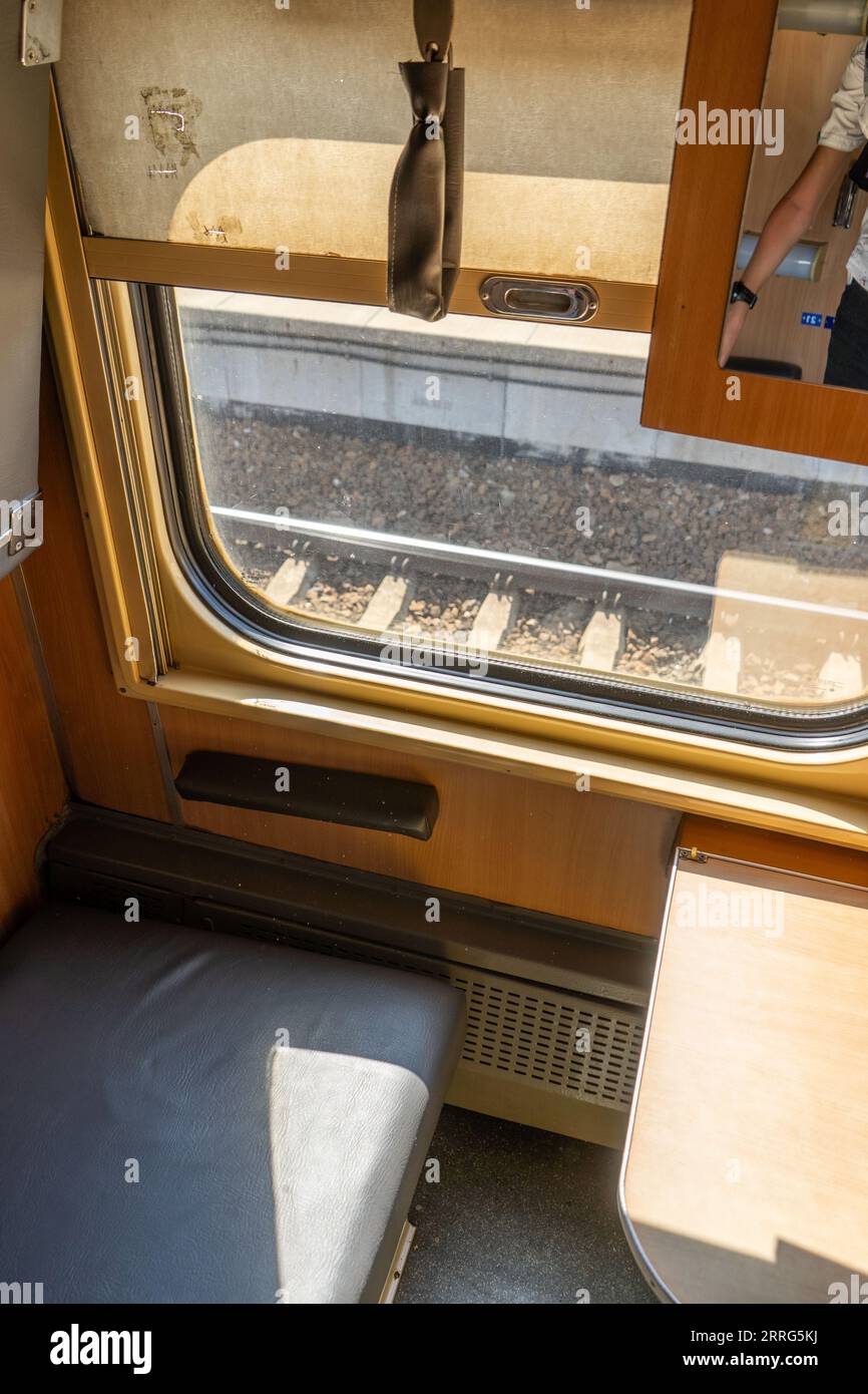 Recumbent seat compartment in the old train Warsaw - Kyiv. View from inside Ukrainian high speed train. Stock Photo