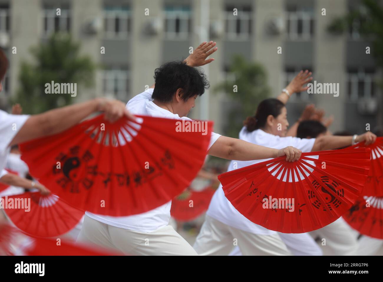 LUANNAN COUNTY, Hebei Province, China - August 8, 2020: People are practicing Tai Chi fans in the square Stock Photo
