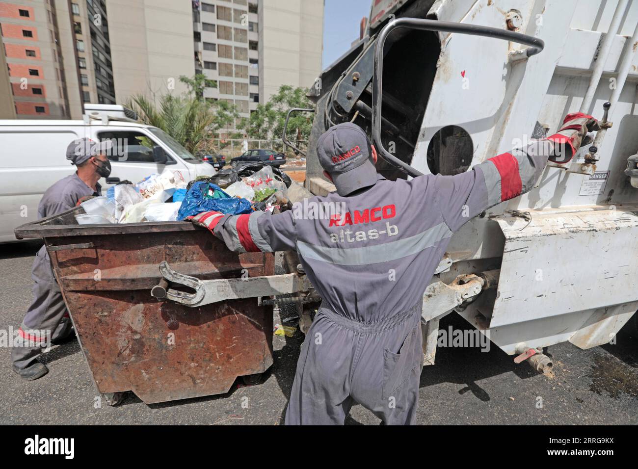 220514 BEIRUT, May 14, 2022 Cleaners collect waste in Beirut