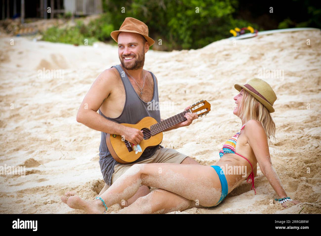 Young couple with ukulele on the beach. Stock Photo