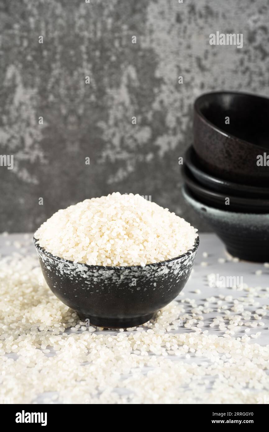 fresh raw organic rice in a plastic cup Stock Photo