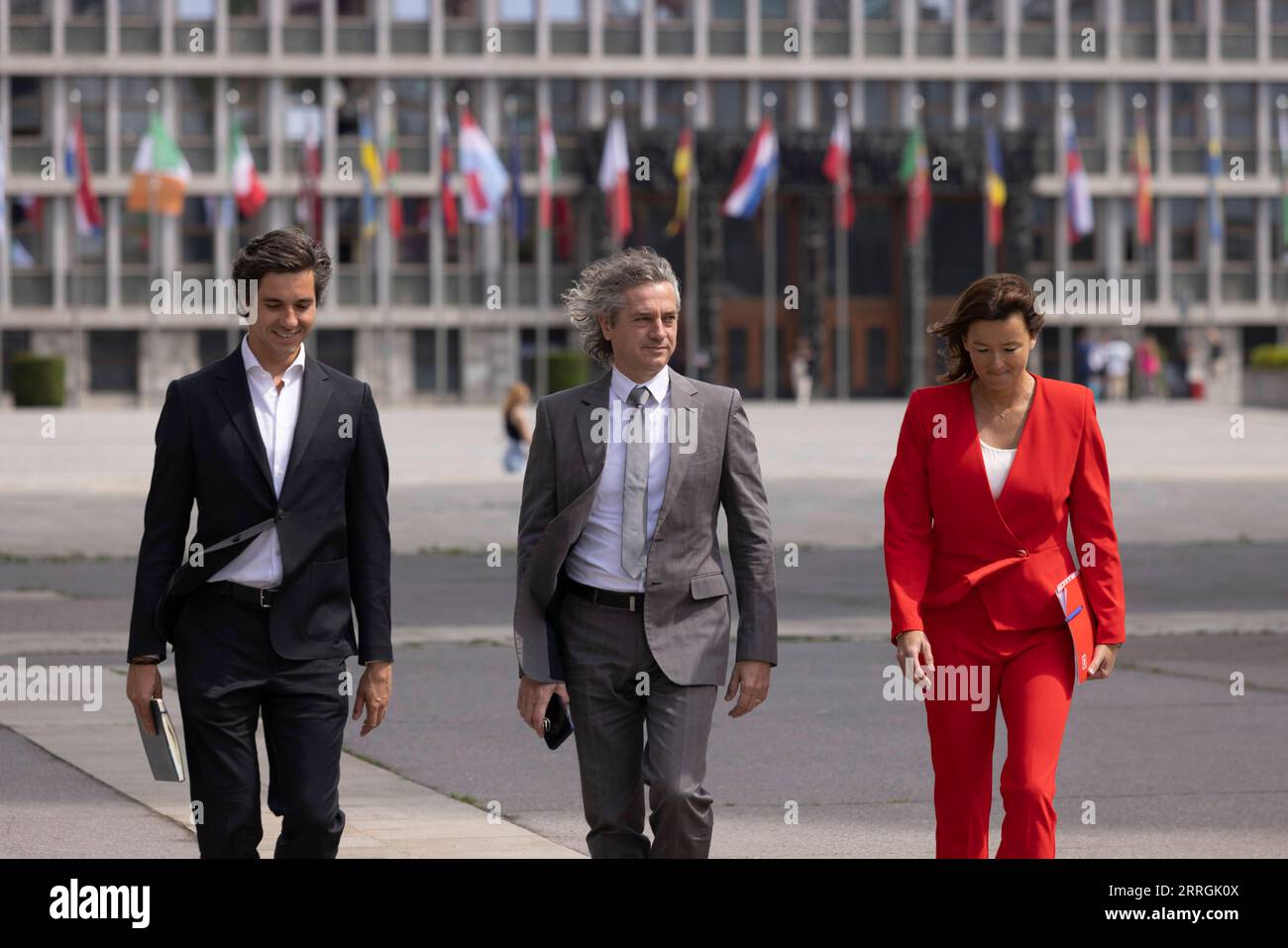 220525 -- LJUBLJANA, May 25, 2022 -- Robert Golob C, leader of the Freedom Movement, Tanja Fajon R, leader of the Social Democrats, and Luka Mesec, leader of the Left, walk in front of the National Assembly Building of Slovenia after signing a coalition agreement in Ljubljana, Slovenia, May 24, 2022. Three Slovenian center-left parties signed a coalition agreement, paving the way for a leftward policy shift, on Tuesday. The move comes a day before parliament is due to confirm leader of the Freedom Movement FM Robert Golob as the country s new prime minister, following the April 24 general elec Stock Photo