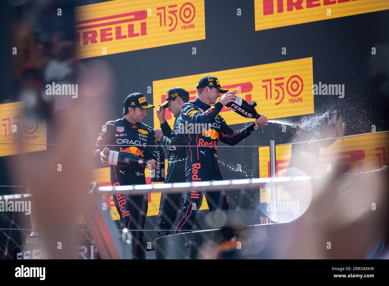 George Russell, Max Verstappen, and Sergio Perez in jubilant celebration, spraying champagne after their victories at the Spanish Grand Prix. Stock Photo