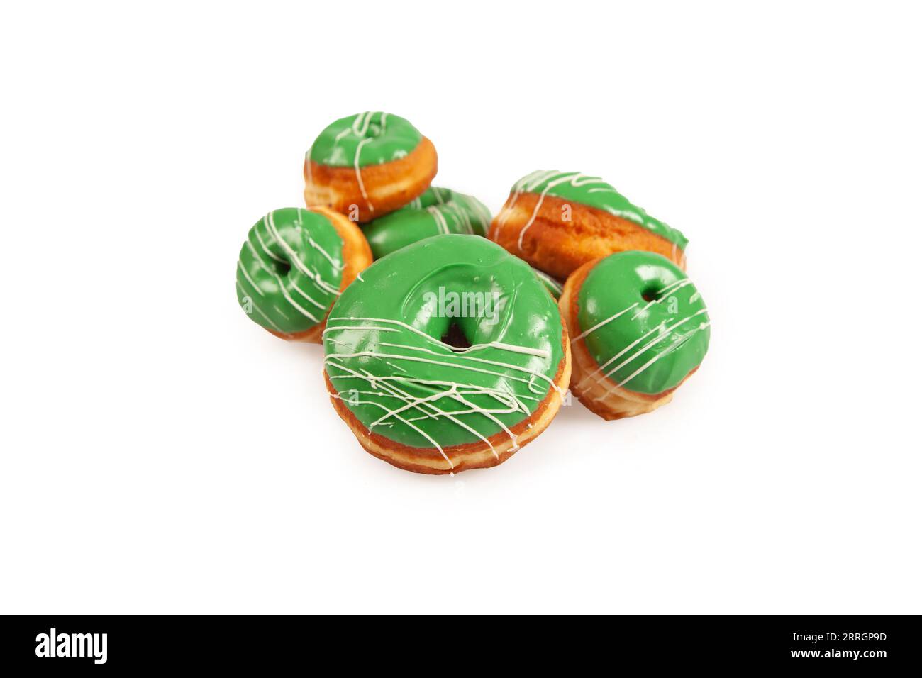 Green coloured large and mini doughnuts with white icing for special occasions. Stock Photo