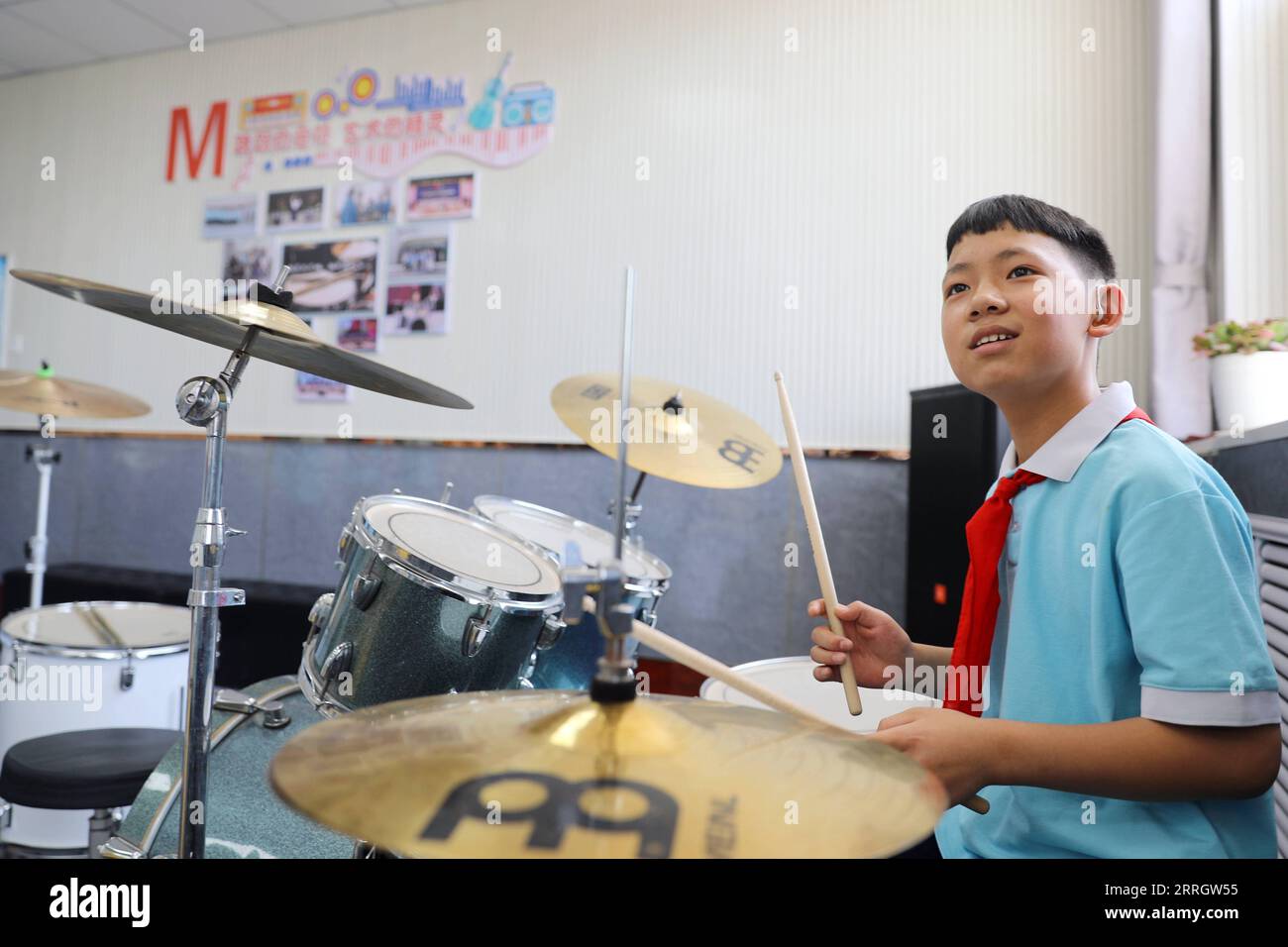220601 -- XINJI, June 1, 2022 -- Student Zhao Kangyuan plays the drum set at the music classroom of Xinji Special Education School in Xinji, north China s Hebei Province, May 31, 2022. In the municipal special-education school of Xinji City, Hebei Province, a jazz drumming band named Against the Wind is making hopeful beats in world of silence. Founded in December 2018, the band is home to 10 students with hearing impairment or intellectual disability. The band has been undergoing systematic and hard training since its establishment and the endeavors paid off when the band made a stunning rend Stock Photo