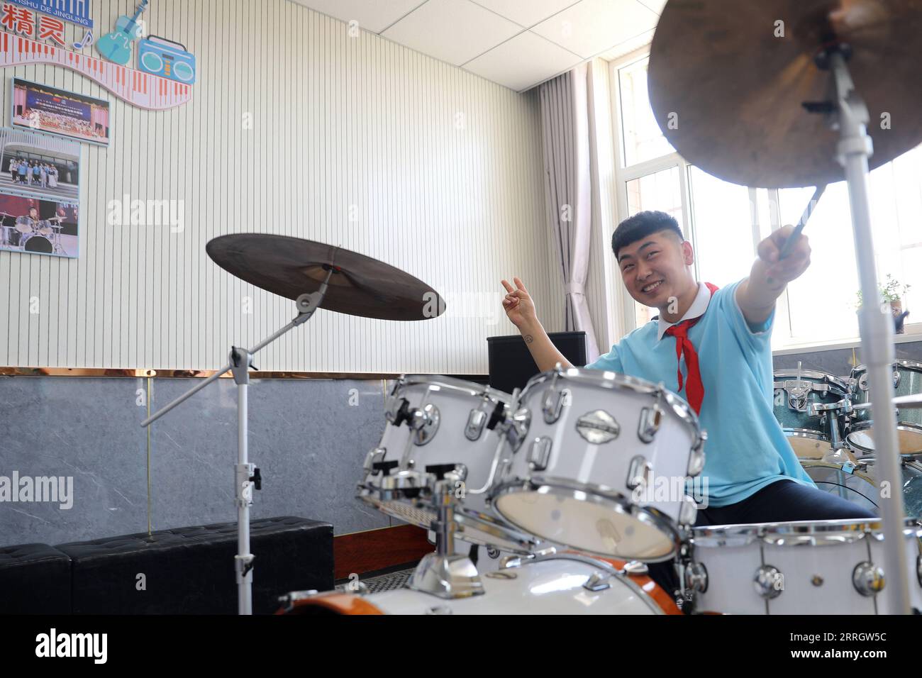 220601 -- XINJI, June 1, 2022 -- Student Wang Hede practices playing the drum set at the music classroom of Xinji Special Education School in Xinji, north China s Hebei Province, May 31, 2022. In the municipal special-education school of Xinji City, Hebei Province, a jazz drumming band named Against the Wind is making hopeful beats in world of silence. Founded in December 2018, the band is home to 10 students with hearing impairment or intellectual disability. The band has been undergoing systematic and hard training since its establishment and the endeavors paid off when the band made a stunn Stock Photo