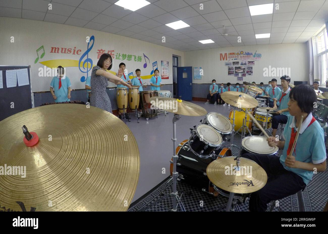 220601 -- XINJI, June 1, 2022 -- Teacher Sun Shicha 2nd L gives instruction to the band at the music classroom of Xinji Special Education School in Xinji, north China s Hebei Province, May 31, 2022. In the municipal special-education school of Xinji City, Hebei Province, a jazz drumming band named Against the Wind is making hopeful beats in world of silence. Founded in December 2018, the band is home to 10 students with hearing impairment or intellectual disability. The band has been undergoing systematic and hard training since its establishment and the endeavors paid off when the band made a Stock Photo