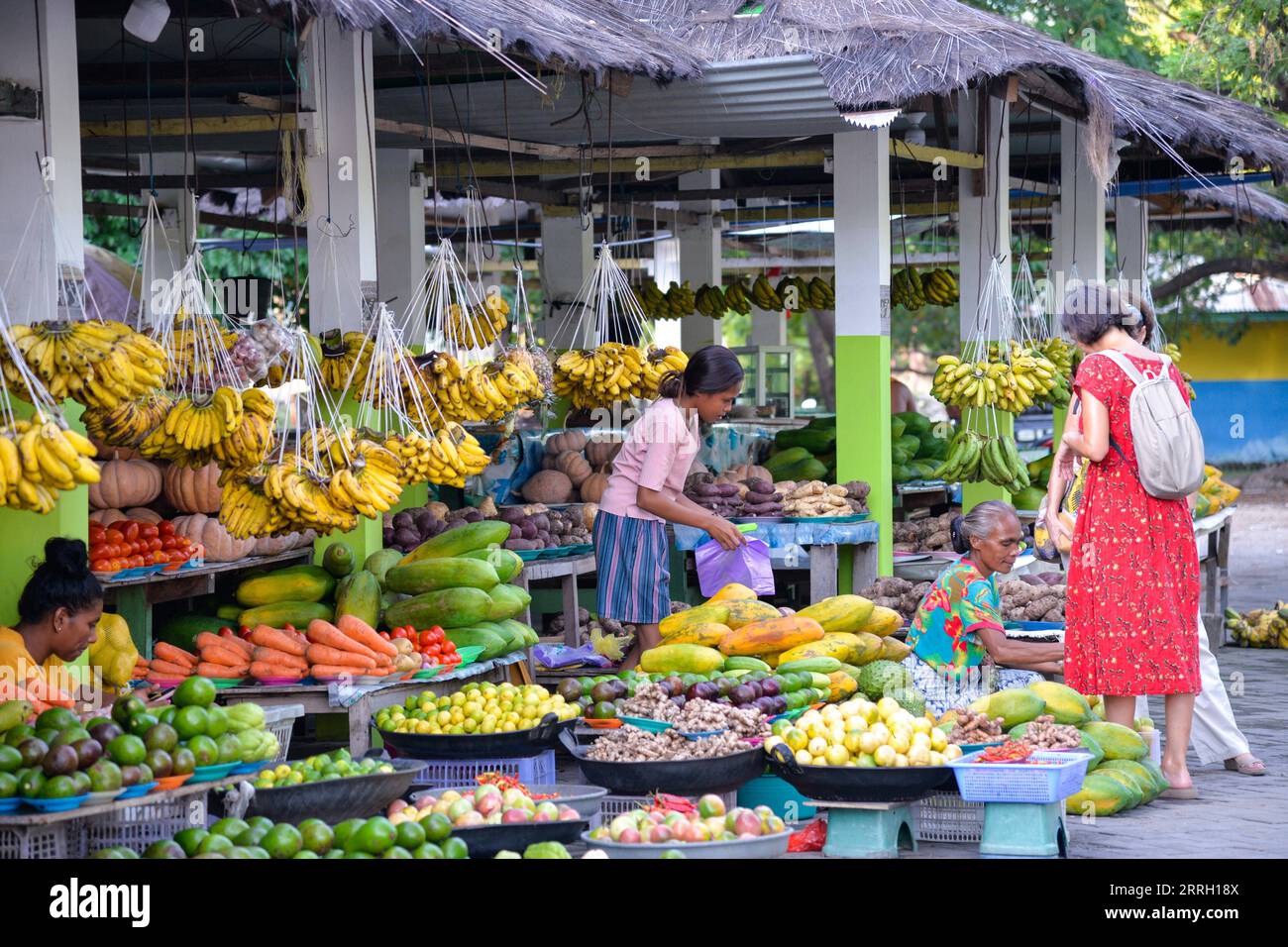 220607 -- DILI, June 7, 2022 -- People shop at a fruit market in Dili