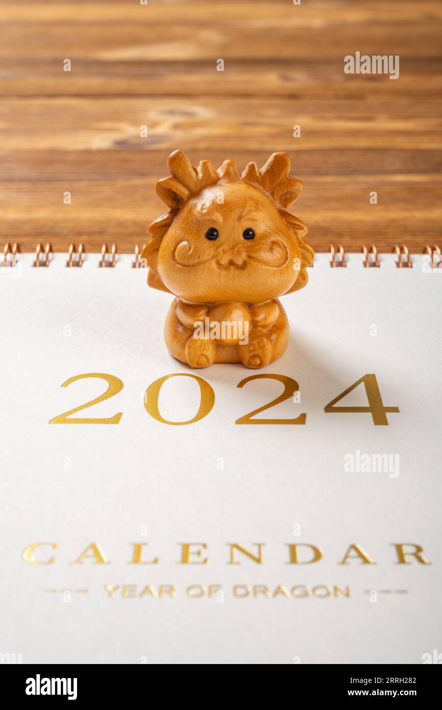 Dragon mascot with a 2024 calendar at vertical composition no logo no trademark Stock Photo