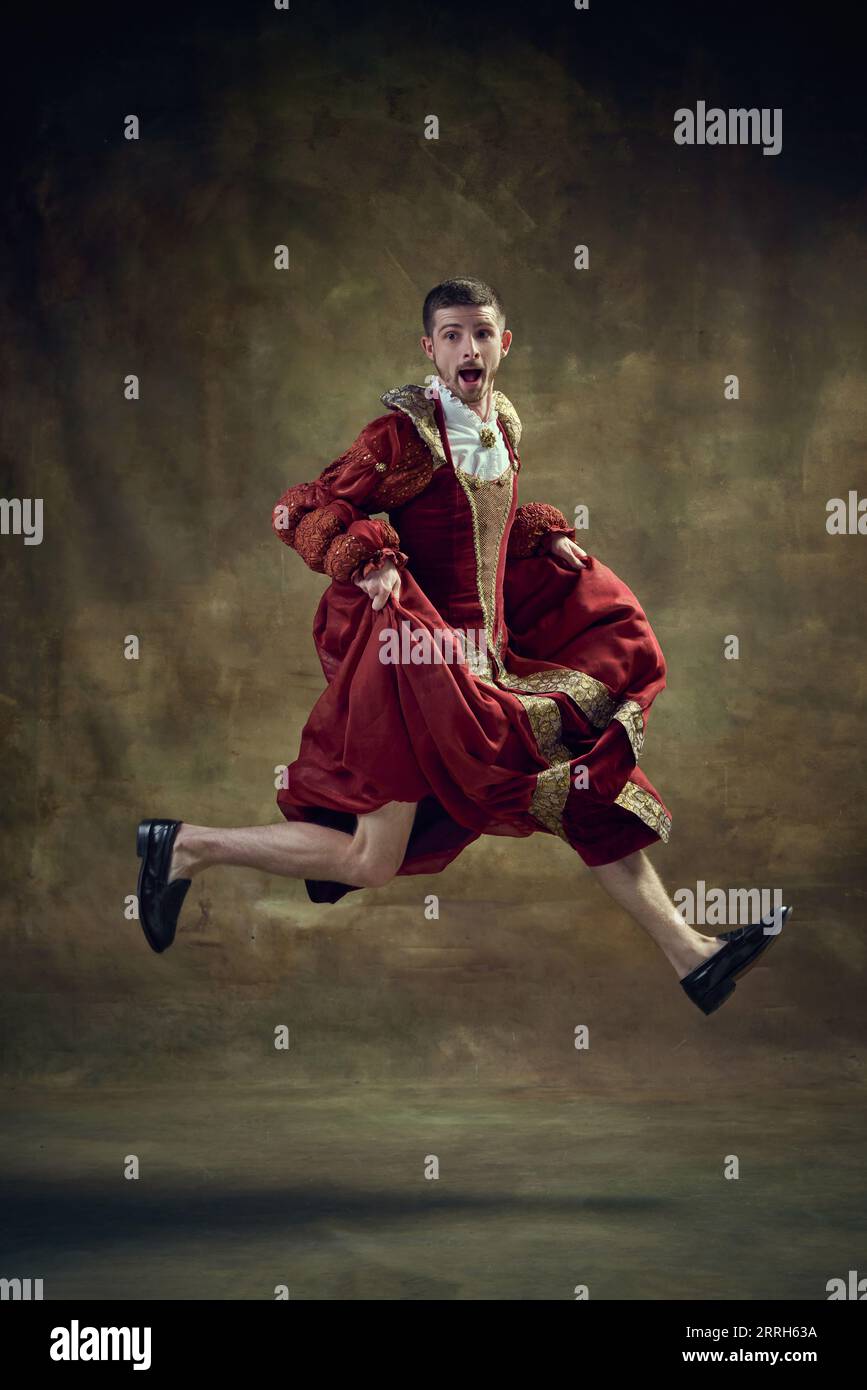 Dramatic apparel. Young man, royal person running on female dress ...