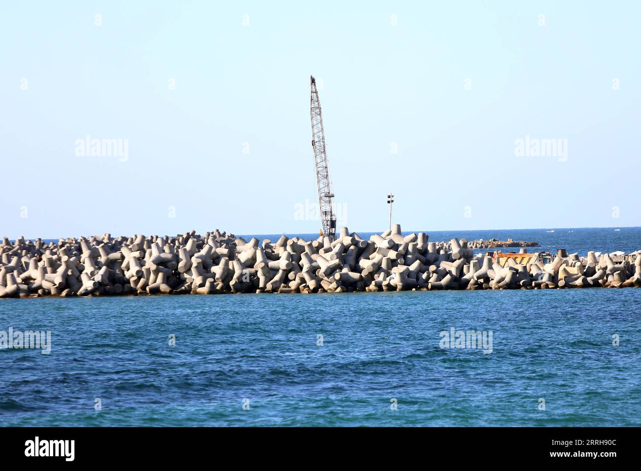 220620 -- ALEXANDRIA, June 20, 2022 -- Concrete barriers used against sea-level rises are seen along the coastline in Alexandria, Egypt, June 19, 2022. The Egyptian Ministry of Water Resources and Irrigation has launched a climate adaptation project on the North Coast and the Nile Delta to counter sea-level rises, the impact of weather hazards on low-lying coastal areas, and seawater intrusion.  EGYPT-ALEXANDRIA-CLIMATE CHANGE-RISING SEA LEVEL-COASTAL CONCRETE BARRIER AhmedxGomaa PUBLICATIONxNOTxINxCHN Stock Photo