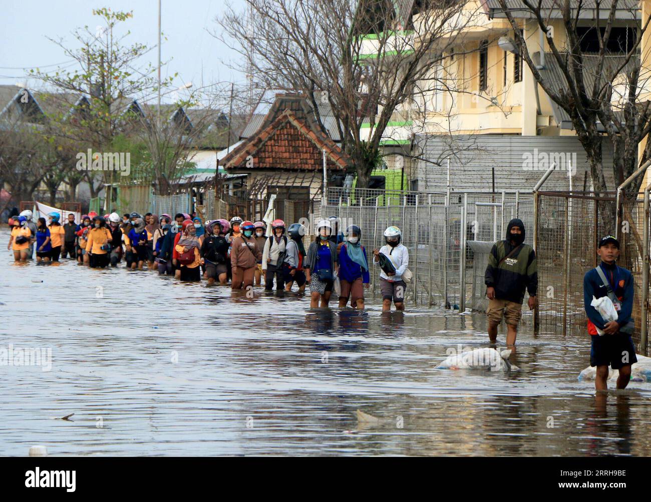 220621 -- SEMARANG, June 21, 2022 -- People wade through flood water ...
