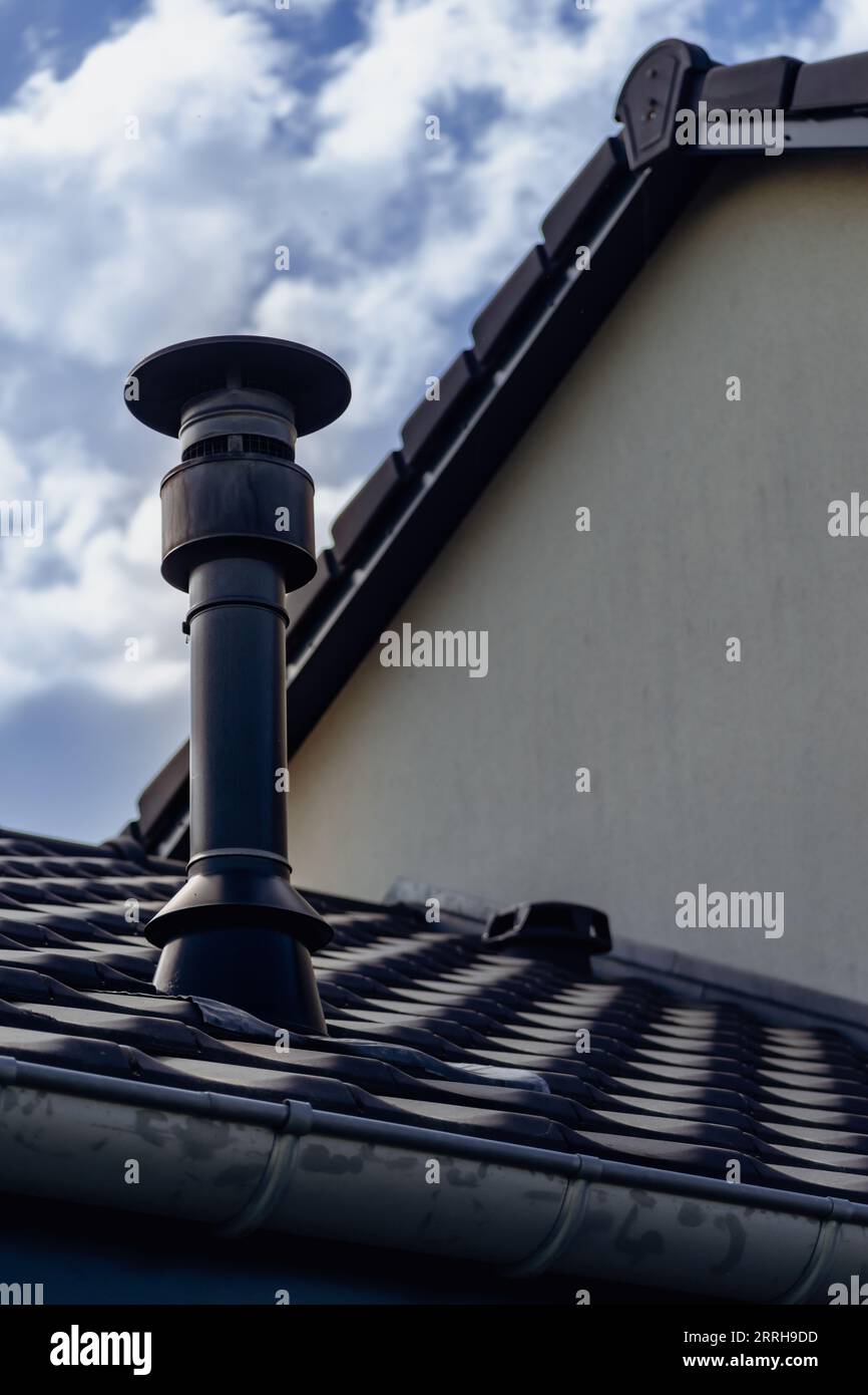 Chimney of a wood or pellet stove installed on the roof Stock Photo Alamy