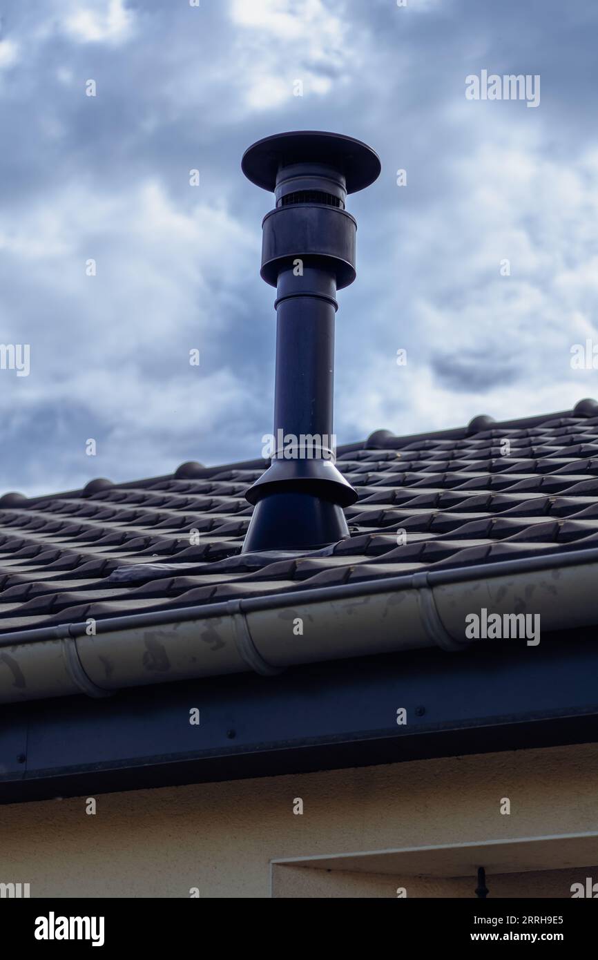 Chimney of a wood or pellet stove installed on the roof Stock Photo Alamy