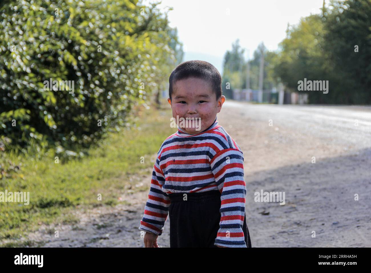 Te cutiest Kyrgyz young kid is smiling, Chon Kemin, Kyrgyzstan Stock Photo