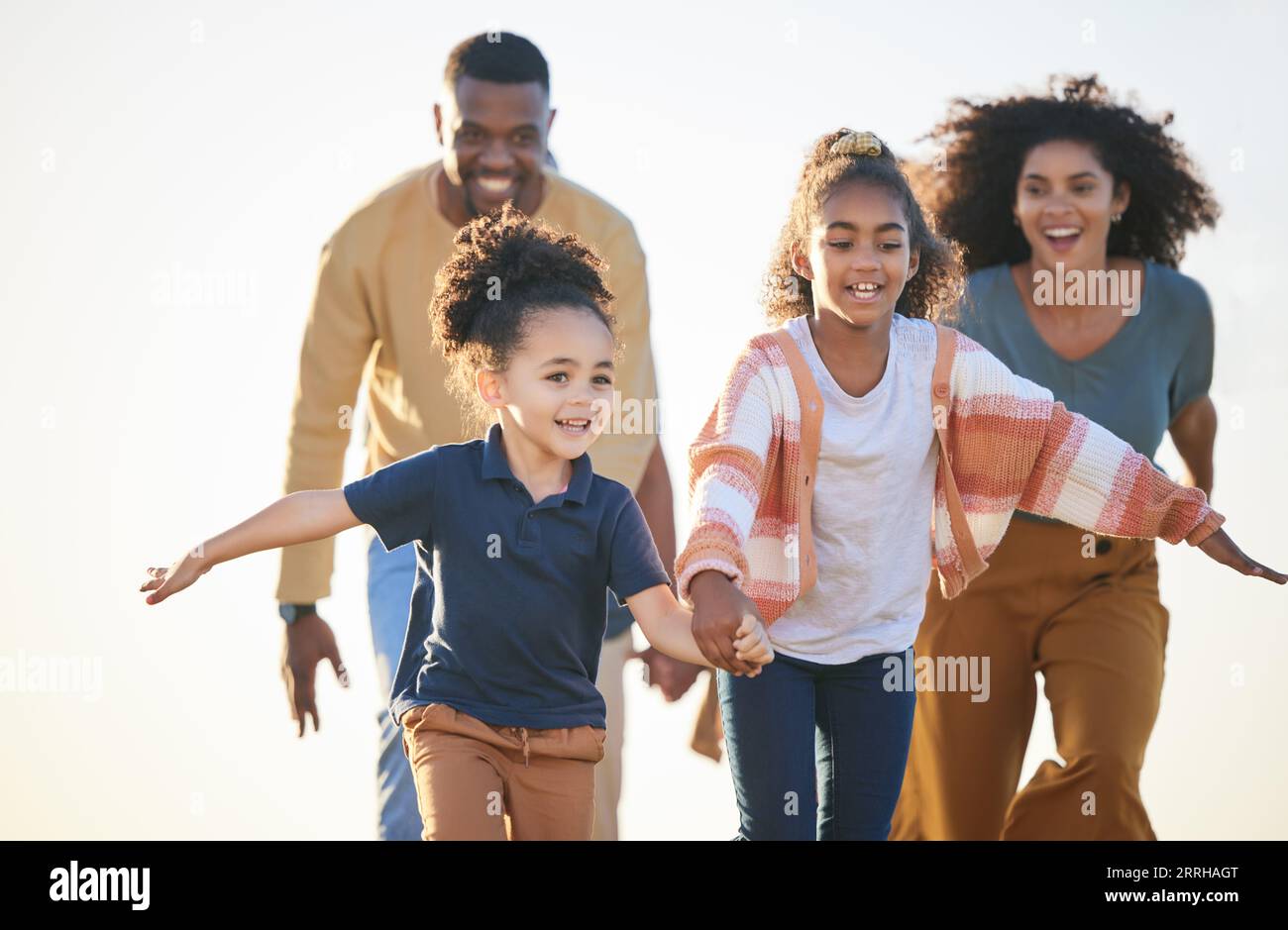 Nature freedom, sky and happy family running, fun race and play games, chase children and connect. Siblings, speed and fast kids holding hands, energy Stock Photo