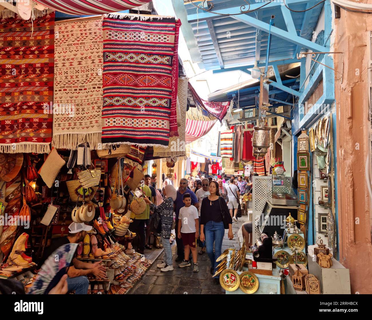 Tunis, Tunisia - 27 August, 2022: People walking in the medina quarter. The Medina contains some 700 monuments, including palaces, mosques, mausoleums Stock Photo