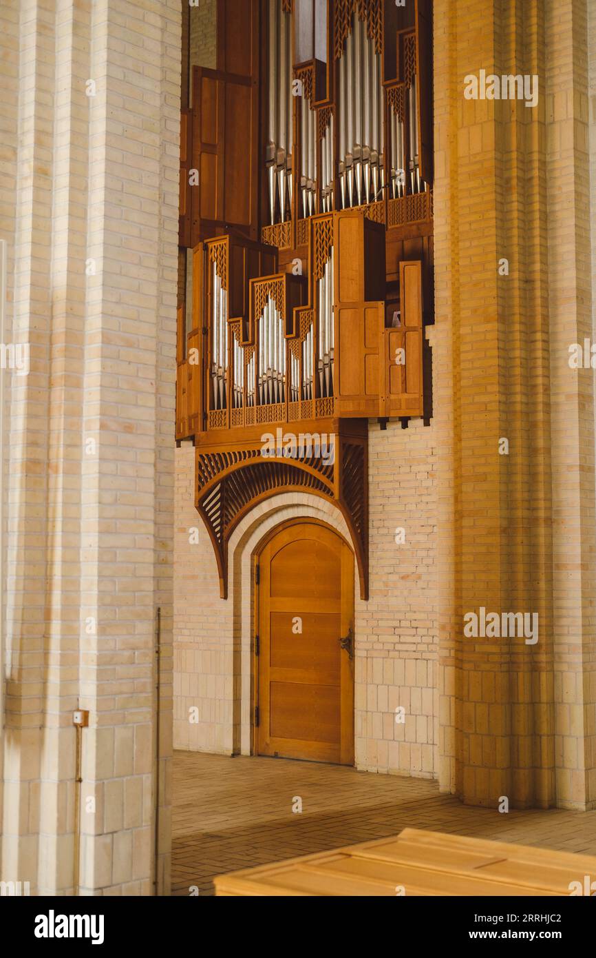North side organ detail in Grundtvig's Church's interior with a wooden door Stock Photo