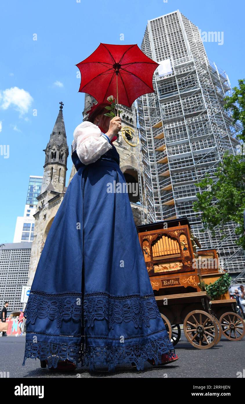 220702 -- BERLIN, July 2, 2022 -- A woman attends a parade of an international barrel organ festival in Berlin, Germany, on July 2, 2022. A total of over 100 barrel organ players entertain visitors with their instruments here from Friday to Sunday.  GERMANY-BERLIN-BARREL ORGAN FESTIVAL RenxPengfei PUBLICATIONxNOTxINxCHN Stock Photo