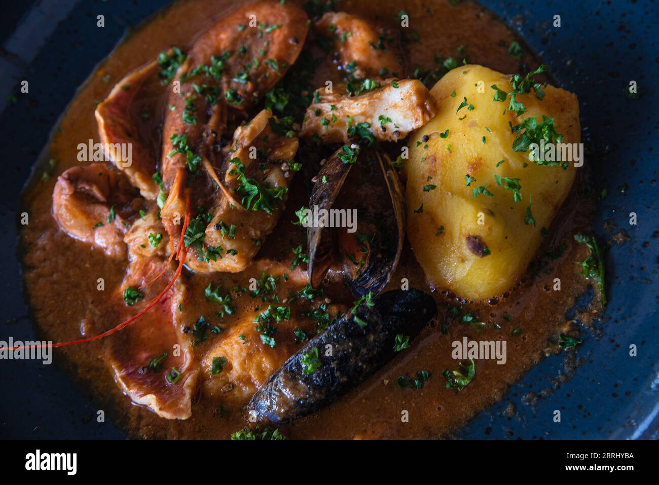Traditional delicious bouillabaisse soup in seaside provencal restaurant in Camargue, France. Simple healthy Mediterranean local dish. Food background Stock Photo