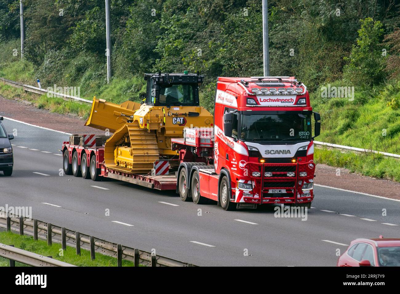Lochwinnoch Motors Ltd. Heavy, Abnormal & General Haulage loads. Large Cat D9 Bulldozer tracked vehicle step-trailer with Abnormal loads travelling on 2018 Scania the M6 motorway in Greater Manchester, UK Stock Photo