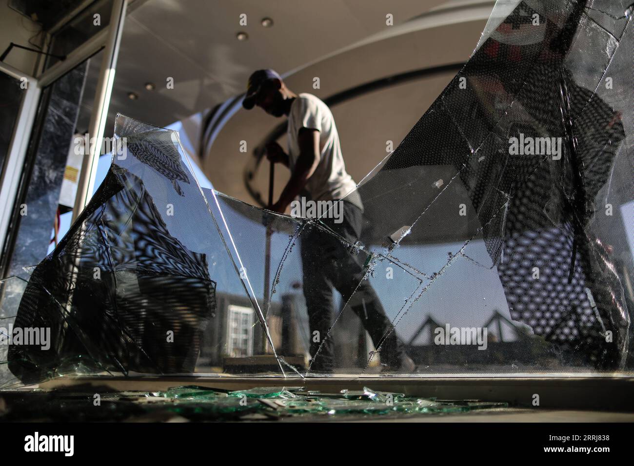 220716 -- GAZA CITY, July 16, 2022 -- A man sweeps glass fragments after an Israeli air strike carried out in Gaza City, on July 16, 2022. Palestinian militants fired four rockets from the Gaza Strip into Israeli territory early Saturday. There were no casualties or damage as a result of the attacks. Israeli Defense Forces IDF responded with an airstrike against targets in Gaza. Photo by /Xinhua MIDEAST-GAZA CITY-AIRSTRIKE YasserxQudih PUBLICATIONxNOTxINxCHN Stock Photo