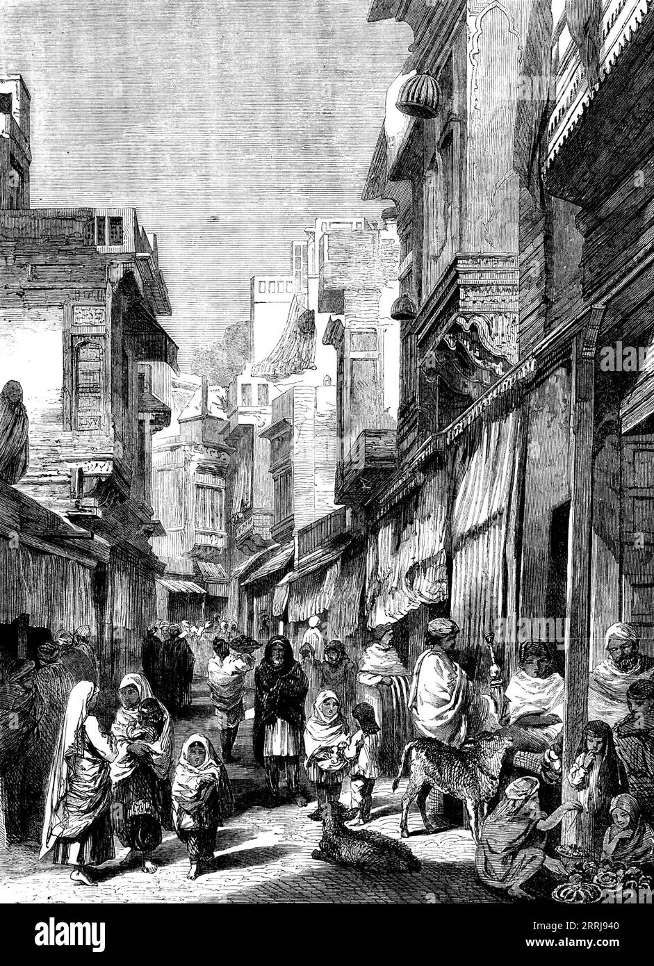 Street Scene in Lahore - from drawings by W. Carpenter, Jun., 1858. '...the capital of the Punjaub...is on the highroad from Central Asia to the rich plains of India, which have been, the desire of every Moslem conqueror...Its brightest time was, perhaps, that when Jehangir made it his winter quarters on returning from Cashmere; and almost the only buildings of importance now remaining date from that period. But its present aspect was given to it during the sovereignty of Runjeet Singh, who built the walls and ditch (about four miles round), together with the fortified palace; and here he and Stock Photo