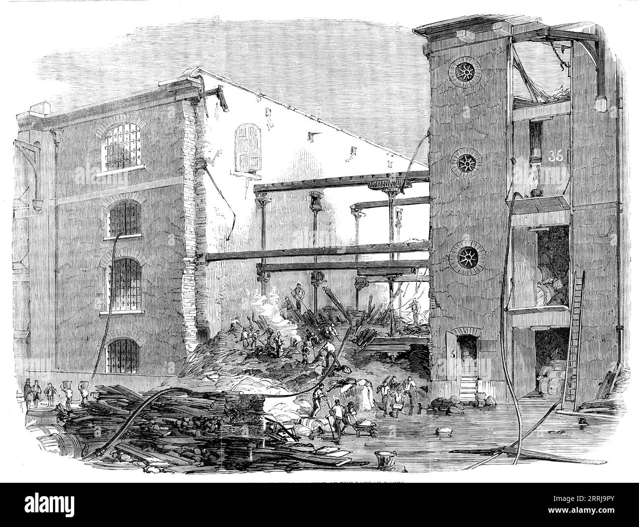 Ruins of the Late Fire at the London Docks, 1858. The fire '...originated in the South Stack Warehouse on the South Quay building, several floors high, each filled with gutta percha, saltpetre, sugar, jute, cider, hemp, ropes, cochineal, saffron, and drugs of great value. To save warehouses containing such combustibles as these proved impossible, and the flames soon got complete possession. The engines arrived very quickly, but torrents of water made no impression on the flames...Just as the conflagration was at its height the gutta percha and indiarubber ran in a state of ignition amongst som Stock Photo