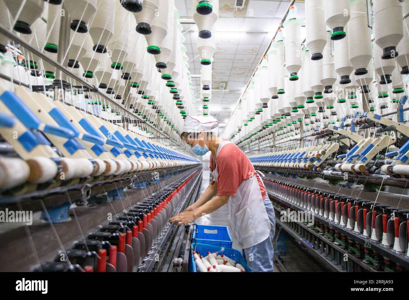 220718 -- BEIJING, July 18, 2022 -- A worker operates on the production line at a textile company in Nanmo Township of Hai an City, east China s Jiangsu Province, Feb. 28, 2022. Photo by /Xinhua Xinhua Headlines: China s steady economic recovery boosts global expectations for future growth ZhaixHuiyong PUBLICATIONxNOTxINxCHN Stock Photo