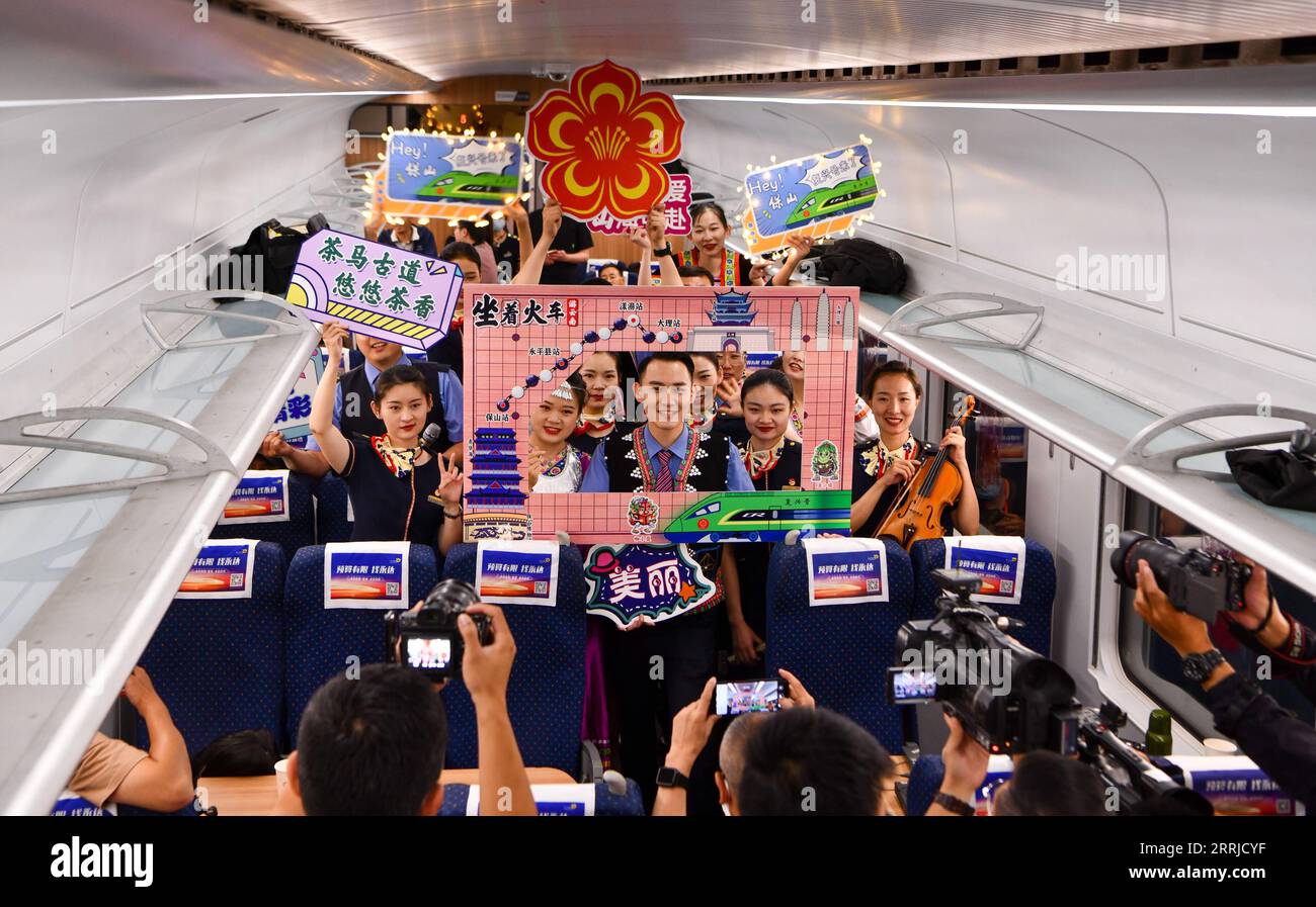 220719 -- KUNMING, July 19, 2022 -- Railway crew pose for a photo aboard a bullet train running for trial along the Dali-Baoshan section of the Dali-Ruili Railway in southwest China s Yunnan Province, July 19, 2022. The Dali-Baoshan section of Dali-Ruili Railway will soon be put into operation, putting an end to Baoshan s status as a place with no rail links. With a length of 330 kilometers, the Dali-Ruili Railway is a major project in China s railway network construction plan.  CHINA-YUNNAN-RAILWAY NETWORK CN JiangxWenyao PUBLICATIONxNOTxINxCHN Stock Photo