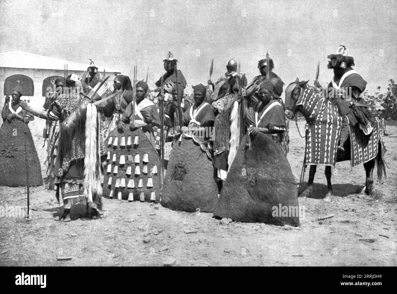 'Distant Fronts, In Cameroon; Escort of the lamido of Rey Bouba, the greatest black king of Cameroon, who came to greet Colonel Brisset; shield bearers and men-at-arms wearing authentic traditional dresss', 1917. From &quot;L'Album de la Guerre 1914-1919, Volume 2&quot; [L'Illustration, Paris, 1924]. Stock Photo