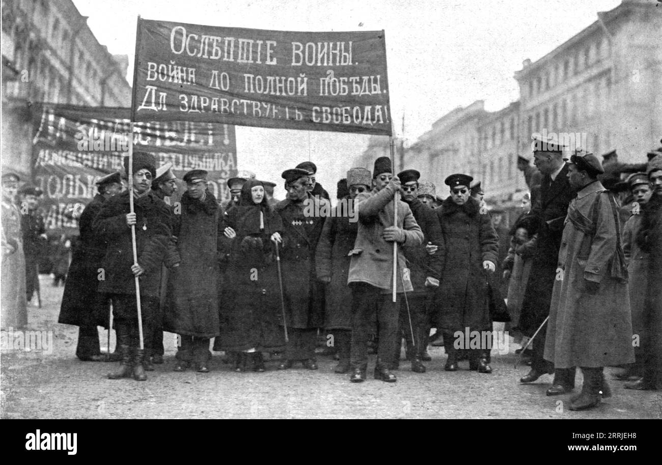 'Les Soubresauts de la Russie; Une contre-manifestation patriotique: des aveugles de guerre, guid&#xe9;s par une infiermiere, promenent a travers Petrograd cette inscription: &lt;&lt;La guerre jusqu'a la victoire complete! Vive la Libert&#xe9;!&gt;&gt;', 1917. Upheavals in Russia: patriotic counter-demonstration: men blinded in the war, guided by a nurse, walk through Petrograd with the slogans: &quot;War until complete victory! Long live freedom!&quot;. From &quot;L'Album de la Guerre 1914-1919, Volume 2&quot; [L'Illustration, Paris, 1924]. Stock Photo