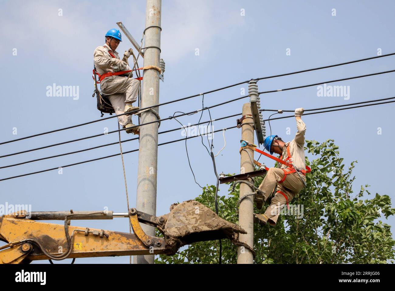 220721 -- NANJING, July 21, 2022 -- Electricians check power facilities after a tornado hit in Huating Village of Xiaoyi Township in Guanyun County, east China s Jiangsu Province, July 21, 2022. A tornado struck Lianyungang City in east China s Jiangsu Province on Wednesday, resulting in one fatality and 25 injured, local emergency management bureau said Thursday. The tornado swept through 11 villages in four townships of Lianyungang at around 12 p.m. on Wednesday. Emergency workers were quick to arrive at the scene and the injured are currently being treated. Relief work is also being carried Stock Photo