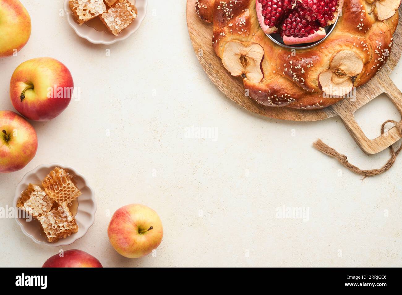 Jewish Holidays - Rosh Hashanah or Rosh Hashana. Pomegranate, apples, honey and round challah on rustic grey table background. Jewish Autumn celebrati Stock Photo